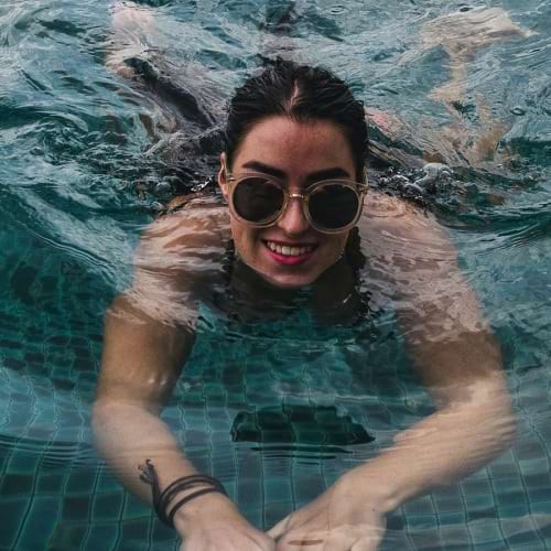 Spacious swimming pool lifestyle image of a woman in a pool