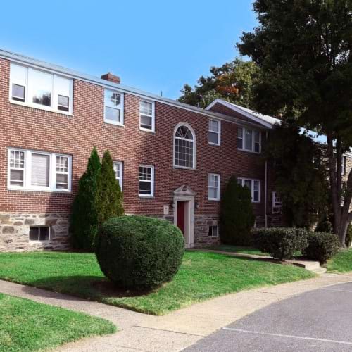 A perfect fit for the whole family a brick building with trees and grass
