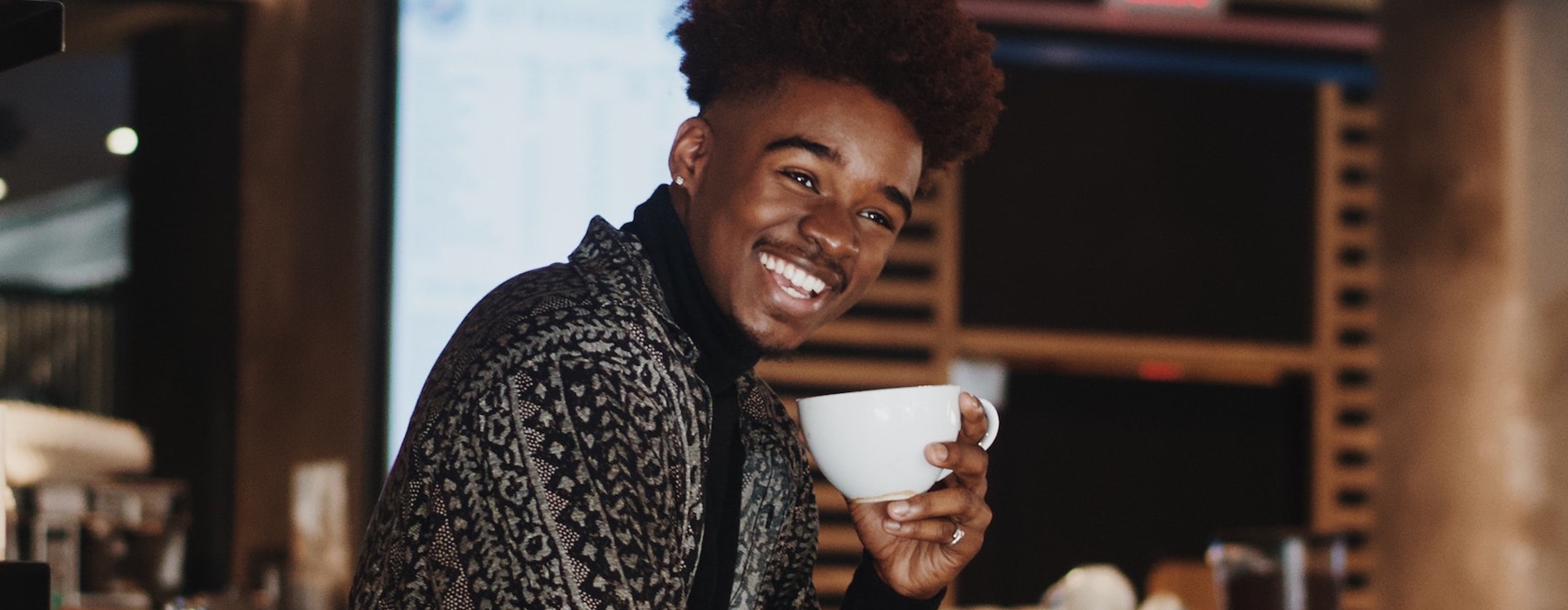 lifestyle image of a barista smiling 